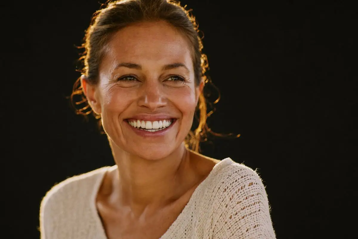 Smiling woman — missing tooth replacement options explained by Midas Dental, Erskineville, Sydney